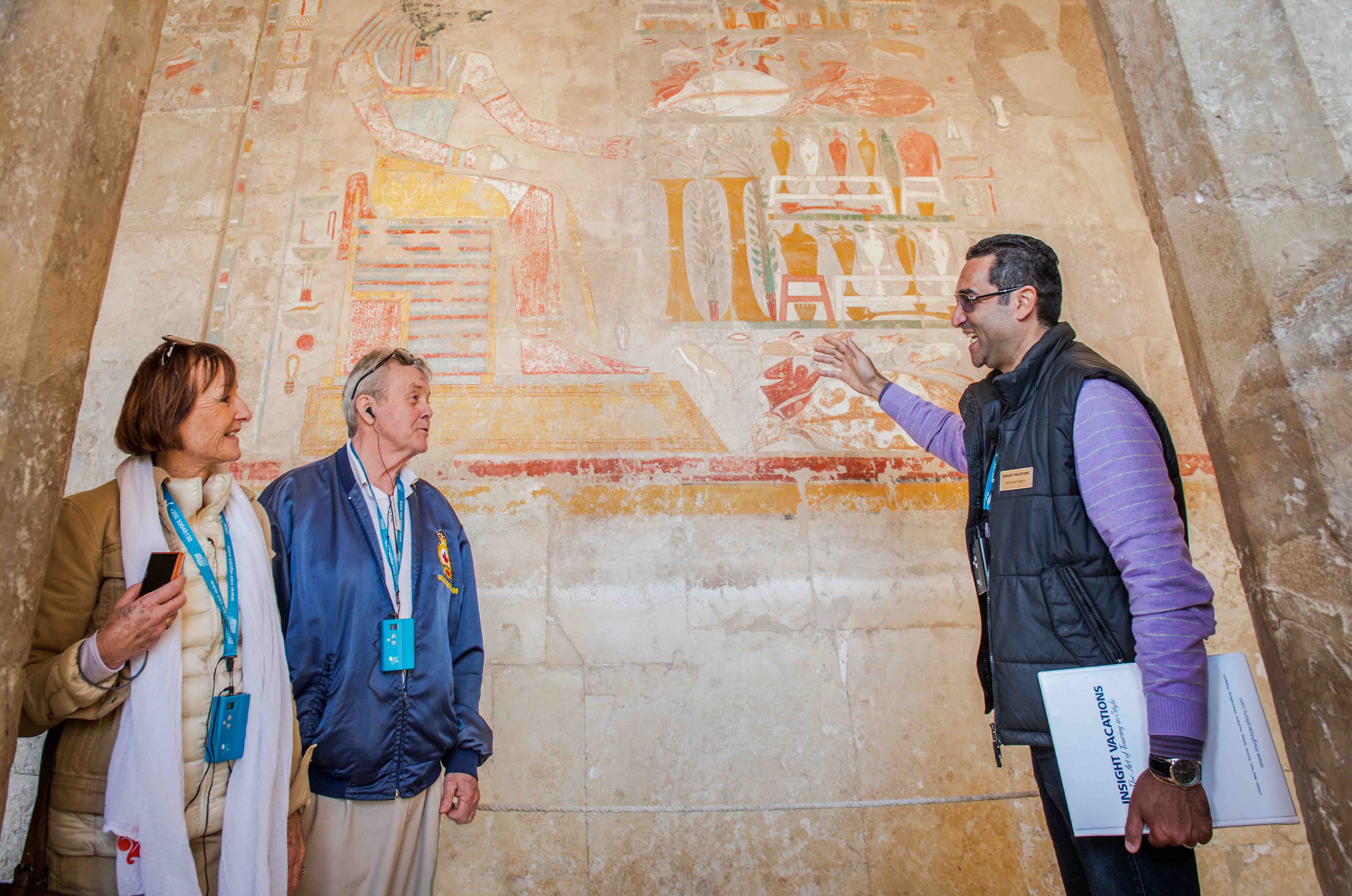 Insight Vacations tour guide Mohammed with guests explaning the Colourful carvings at Temple of Queen Hatshepsut