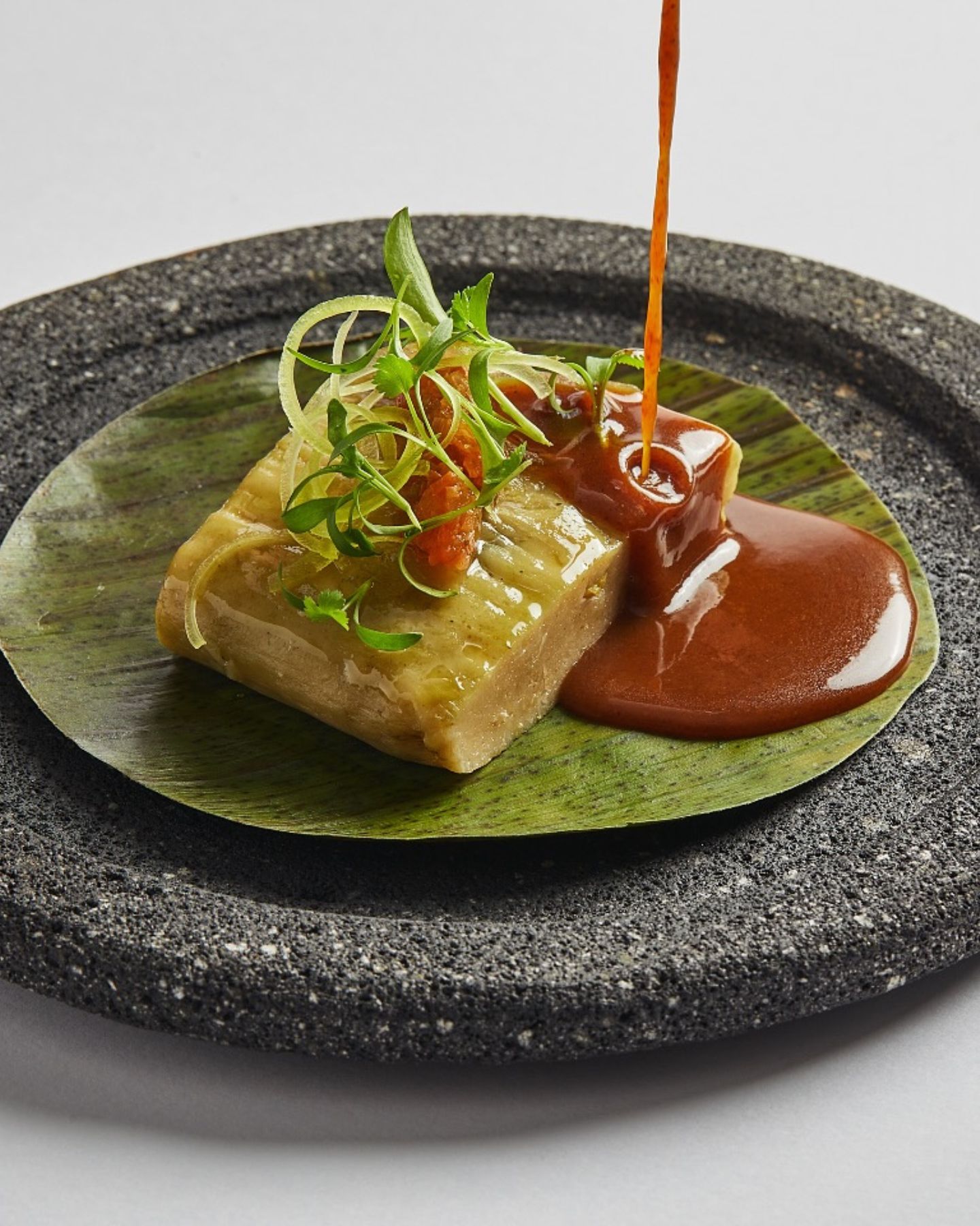 Smoked Yucatecan pumpkin tamal colado, served with a rich meat broth and Corazón de Mantequilla cheese. Photo: Kuuk Restaurant