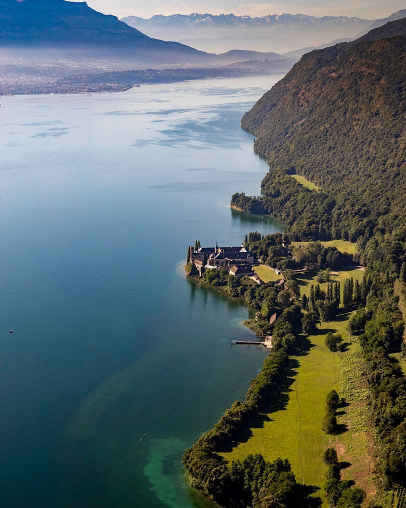 View of Lake Bourget’s unspoilt coastline with turquoise water and surrounding Alpine hills