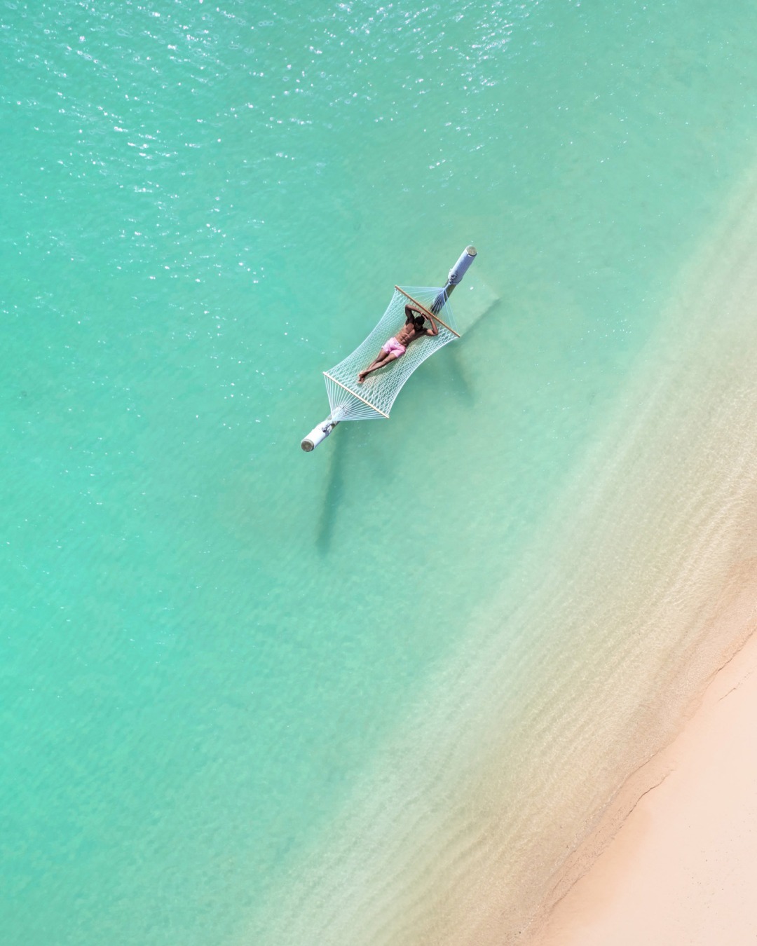 Pink sand beach with hammocks at Hamilton Princess Beach Club in Bermuda