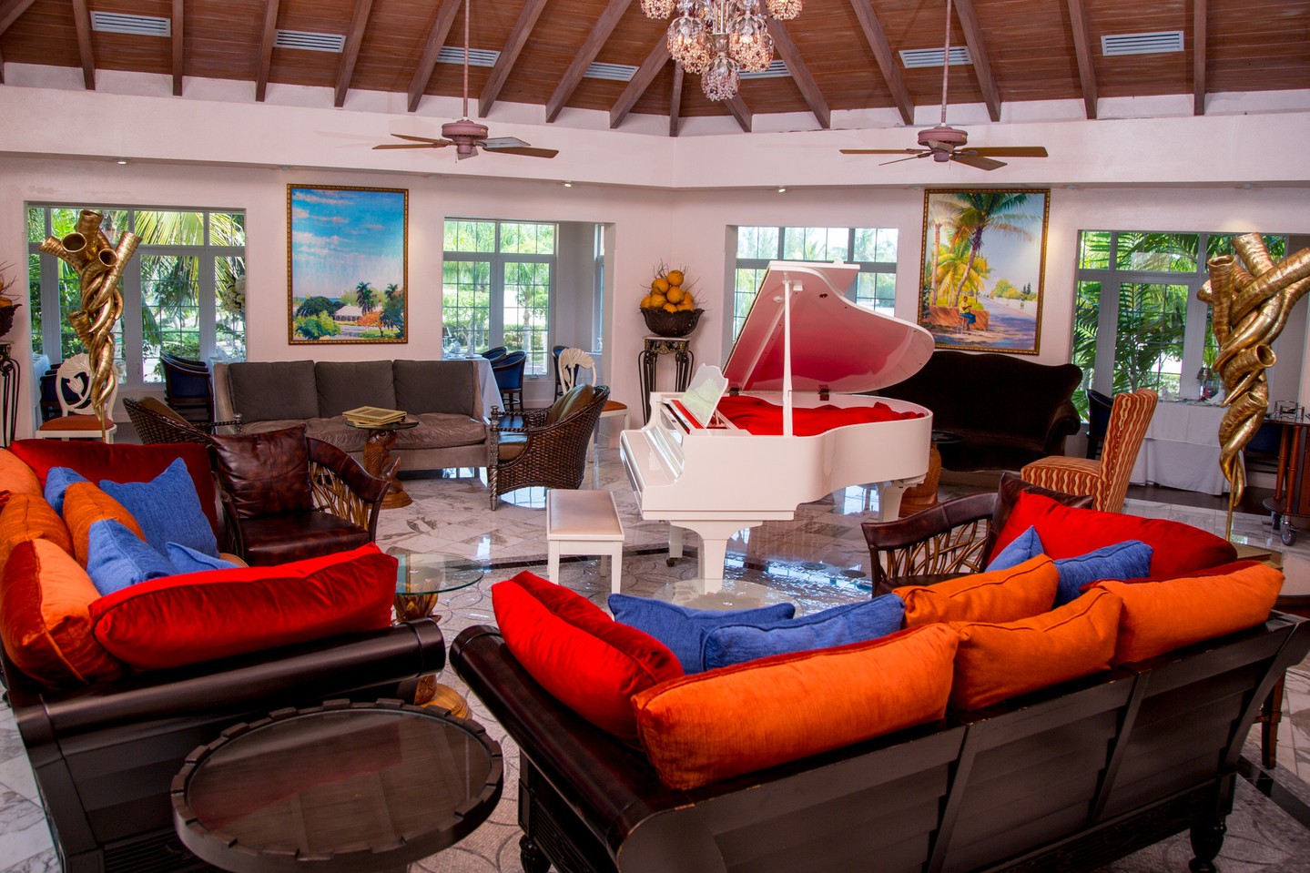 Sapodilla Restaurant impresses with four striking dining spaces, filled with heirlooms, period furniture, and a lively piano bar, creating a vibrant blend of history and hospitality.