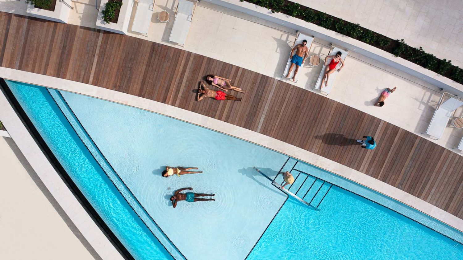 Infinity pool at Goldwynn Resort blends seamlessly into the Caribbean blue, inviting relaxation and a leisurely float.