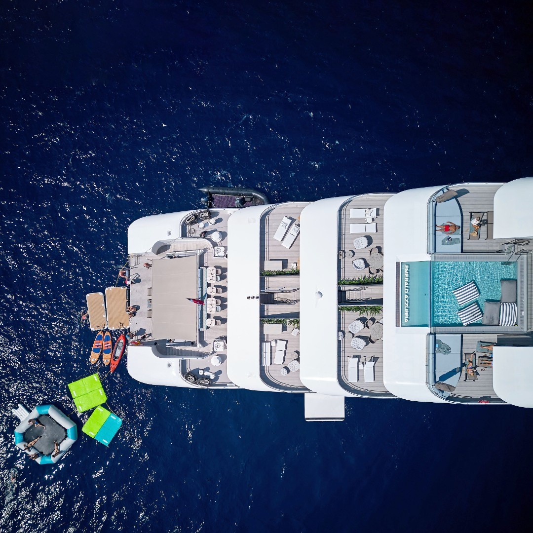Aerial view of the Emerald Azzurra’s Aqua Pool, showing sun loungers, shaded seating, and the poolside café.