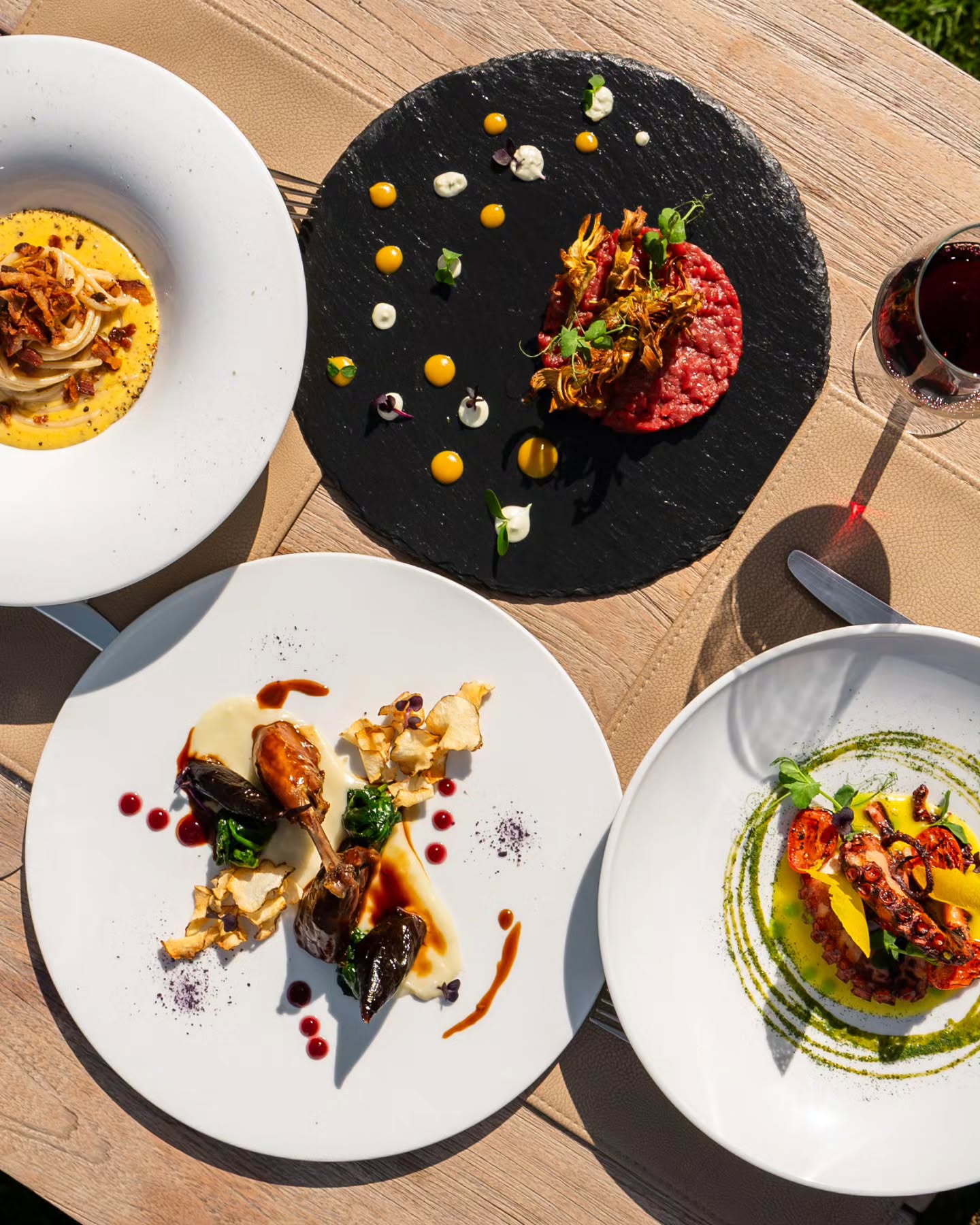 A rustic Umbrian table setting with local dishes and wine at Il Caldaro, Tenuta di Murlo’s signature restaurant.