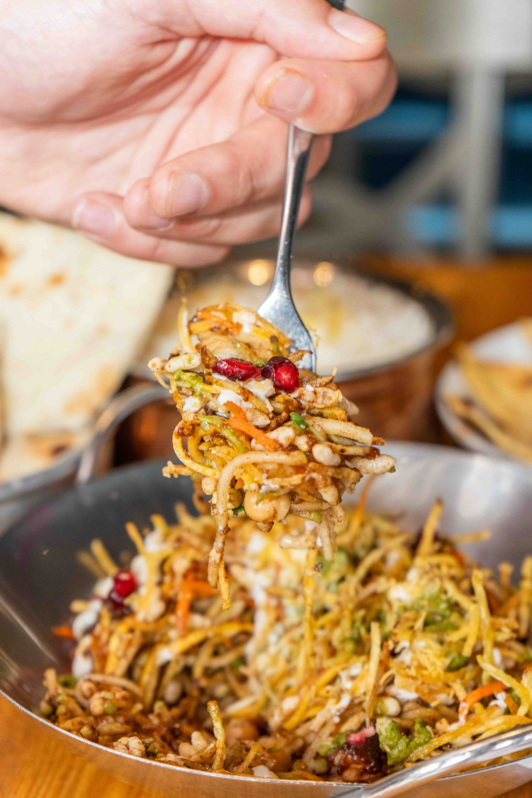 Pukka Chaat Salad deconstructed with puffed rice, mango, pomegranate, green apple, chutneys and yogurt at Pukka Toronto