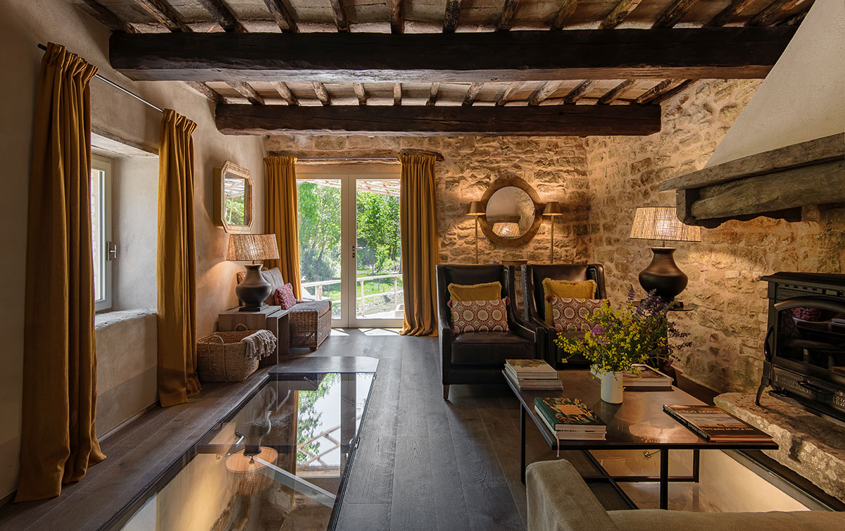nside Villa Molinella: rustic charm meets modern comfort, where stone walls and warm textures create a serene retreat.