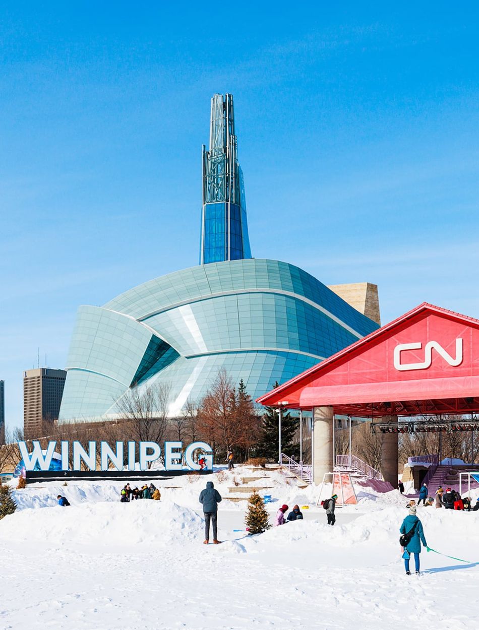 View of Winnipeg’s skyline from The Forks National Historic Site, a must-visit destination for culture, dining, and riverside walks. Photo: Mark Sissons
