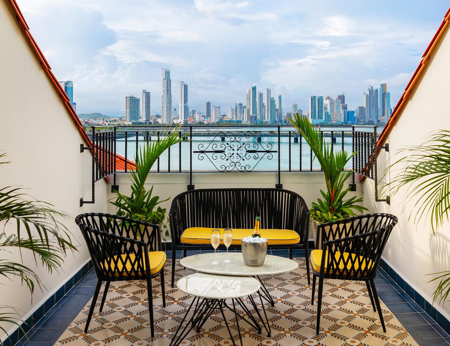 View from a black-iron railed balcony overlooking the square where Sofitel Legend Casco Viejo sits in Panama City’s UNESCO historic district.