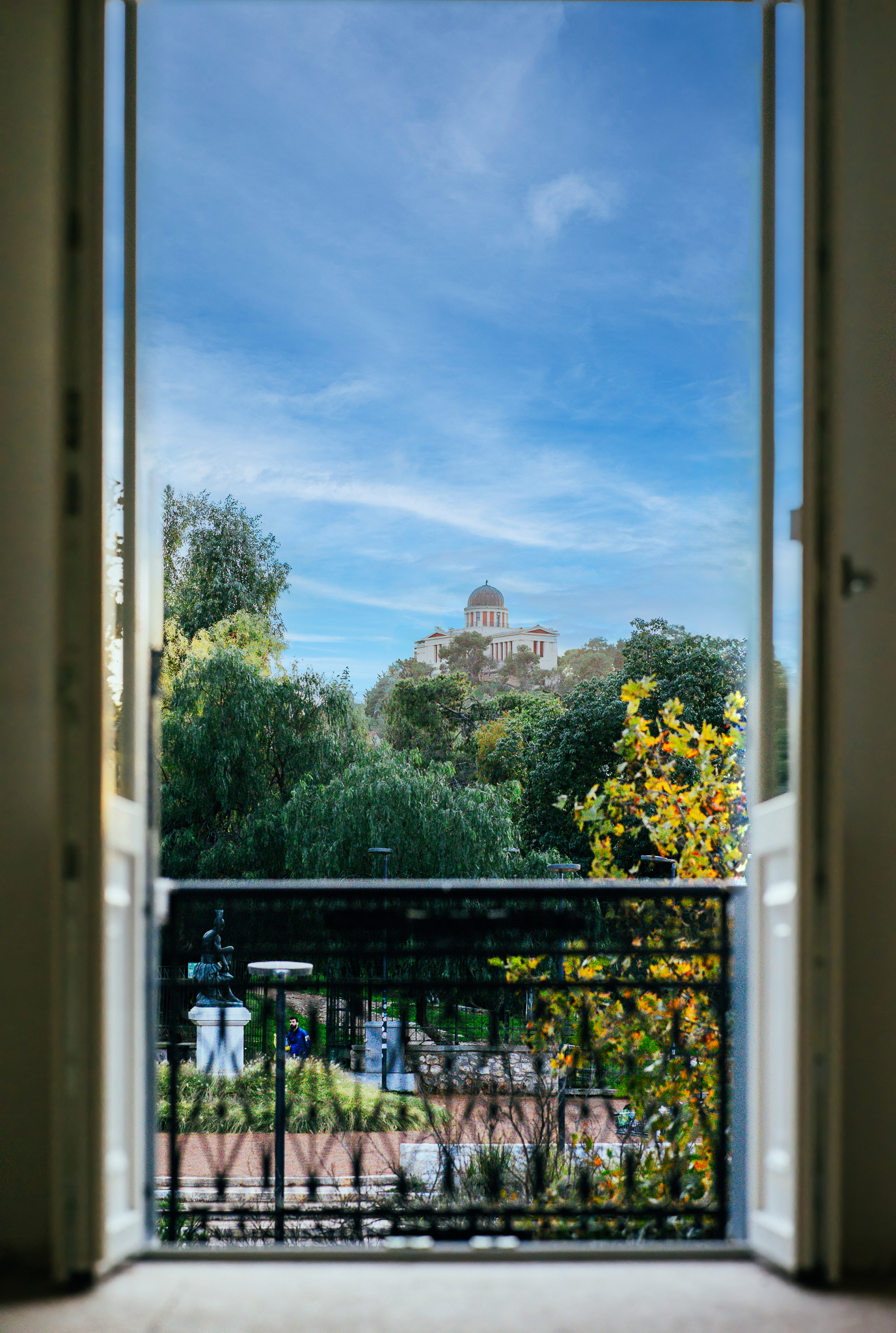 he view from La Divina hotel in Athens, Greece, looking toward the Acropolis. Housed in a historic neoclassical building originally built in 1897, this boutique hotel is inspired by opera diva Maria Callas and was once home to the Athenaeum Conservatory.