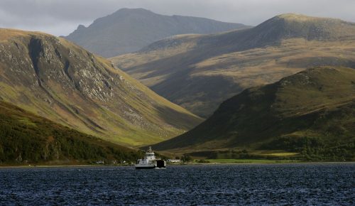 The ferry from the Isle of Arran to Skipness on Kintyre Argyll. The hills of Arran and the tiny village of Catacol in the background
