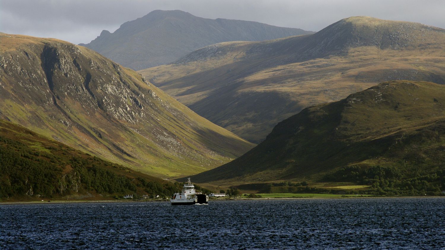 The ferry from the Isle of Arran to Skipness on Kintyre Argyll. The hills of Arran and the tiny village of Catacol in the background