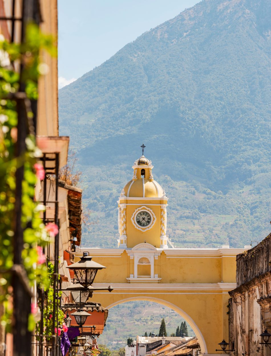Antigua Guatemala, classic colonial town with famous Arco de Santa Catalina and Volcan de Agua behind
