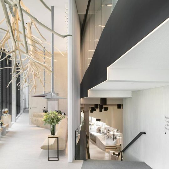 The lobby of Hôtel des Horlogers in Le Brassus, Switzerland. Designed by the Bjarke Ingels Group (BIG) to blend with the natural landscape of the Jura Mountains, the interiors feature large-format porcelain tiles from Atlas Concorde and raw local materials that create a welcoming atmosphere.