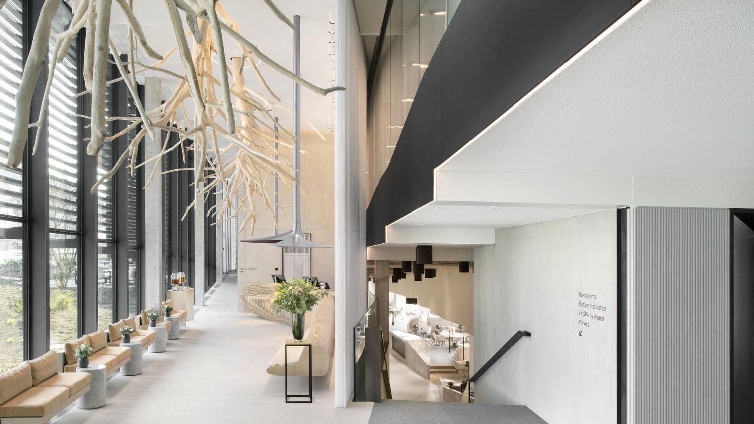 The lobby of Hôtel des Horlogers in Le Brassus, Switzerland. Designed by the Bjarke Ingels Group (BIG) to blend with the natural landscape of the Jura Mountains, the interiors feature large-format porcelain tiles from Atlas Concorde and raw local materials that create a welcoming atmosphere.